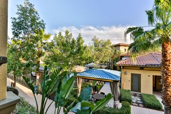Lush landscaping with outdoor patio space throughout